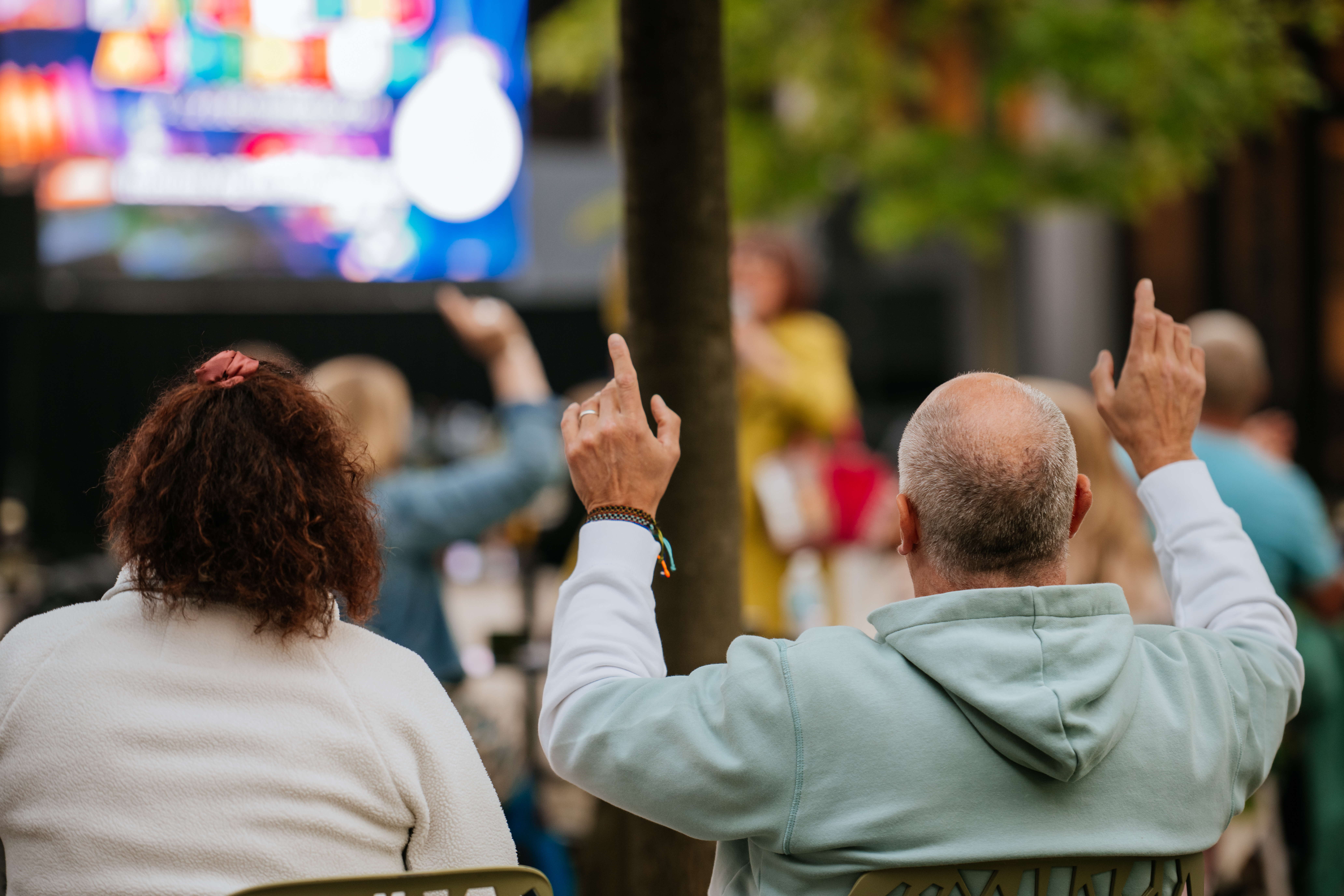 Visitors watch a performance onsite at the Arboretum