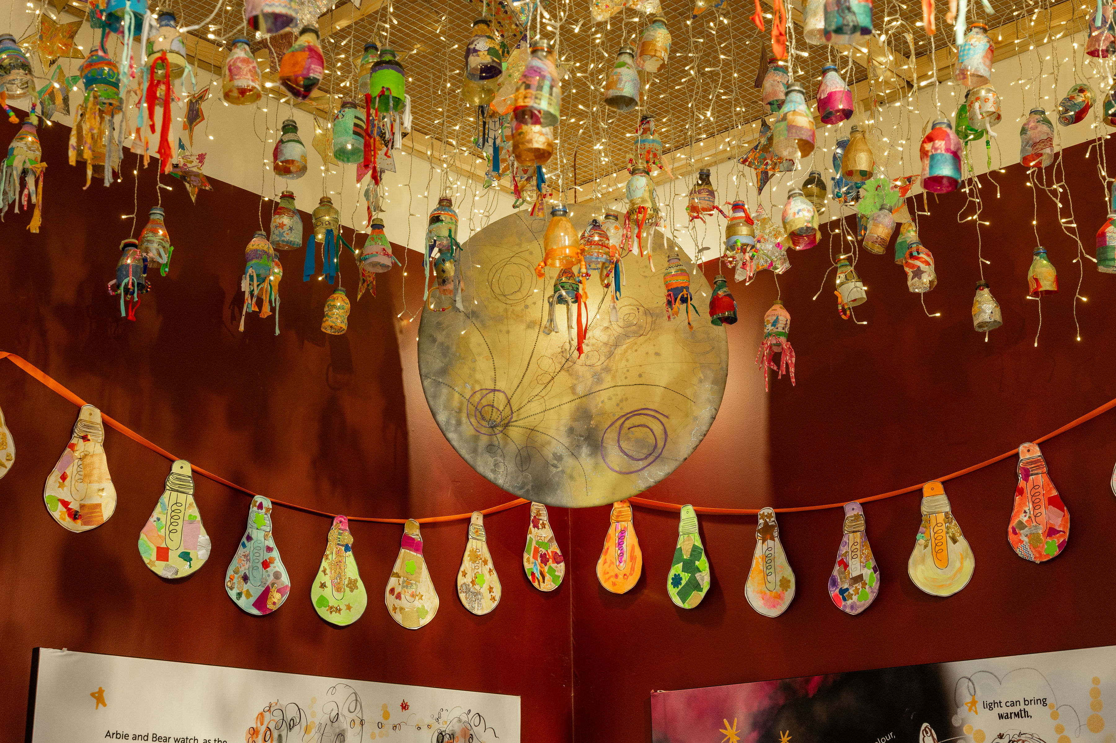 Nearly 1000 lanterns created by local school children from recycled plastic bottles hang from the Arboretum's ceiling.