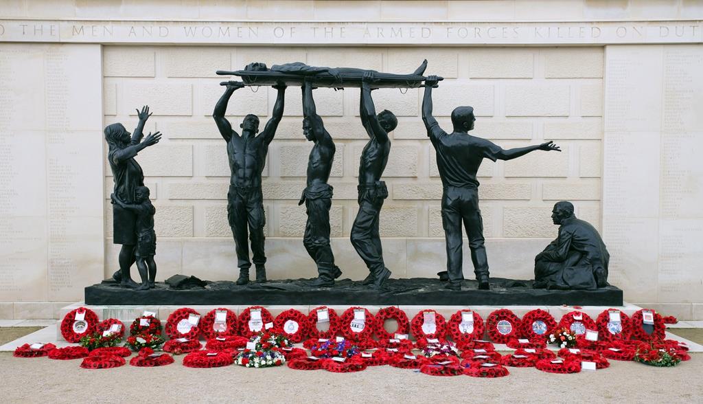 Statue on the Armed Forces Memorial with Poppy Wreaths surrounding it
