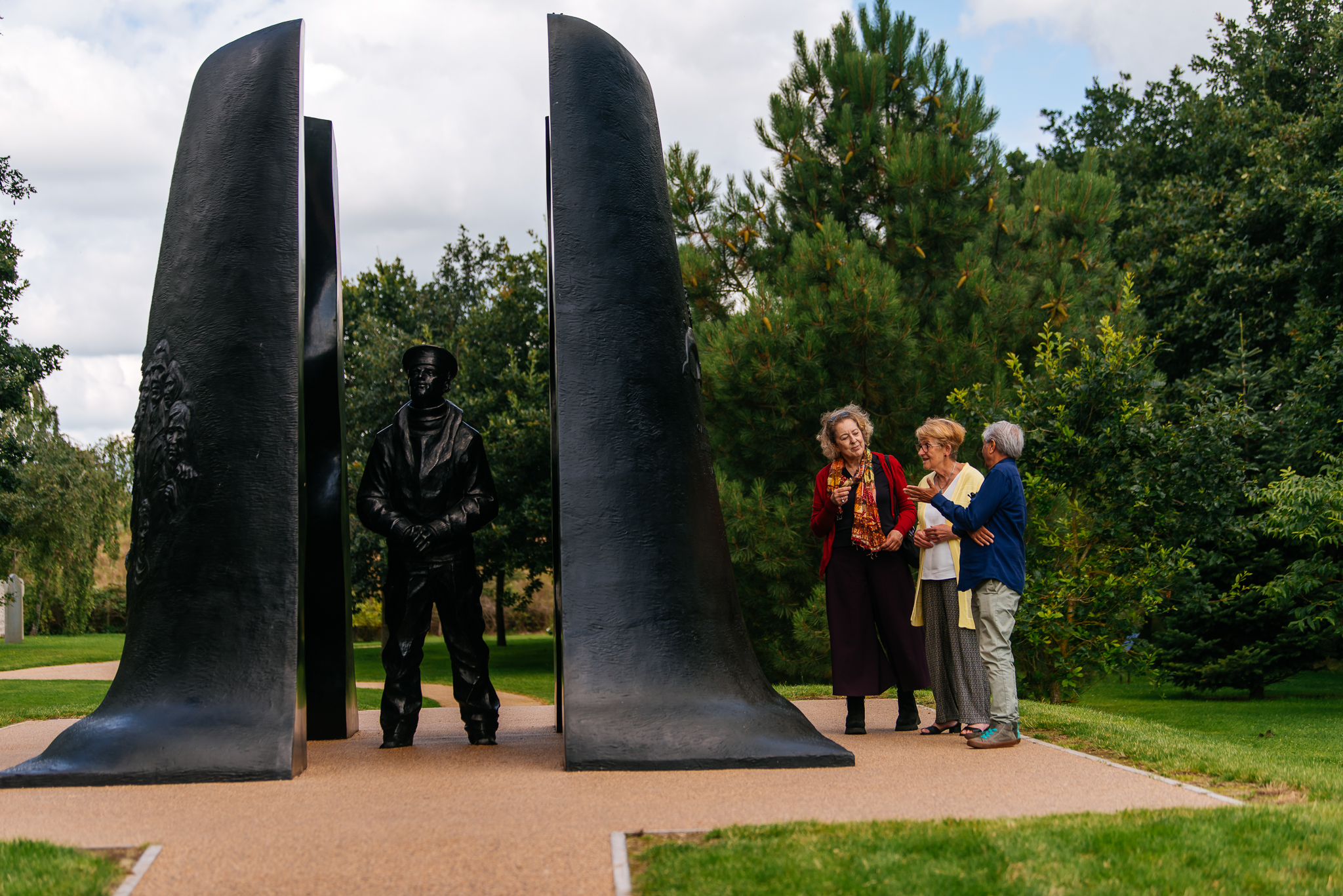 A group of people looking at the Submariners Memorial